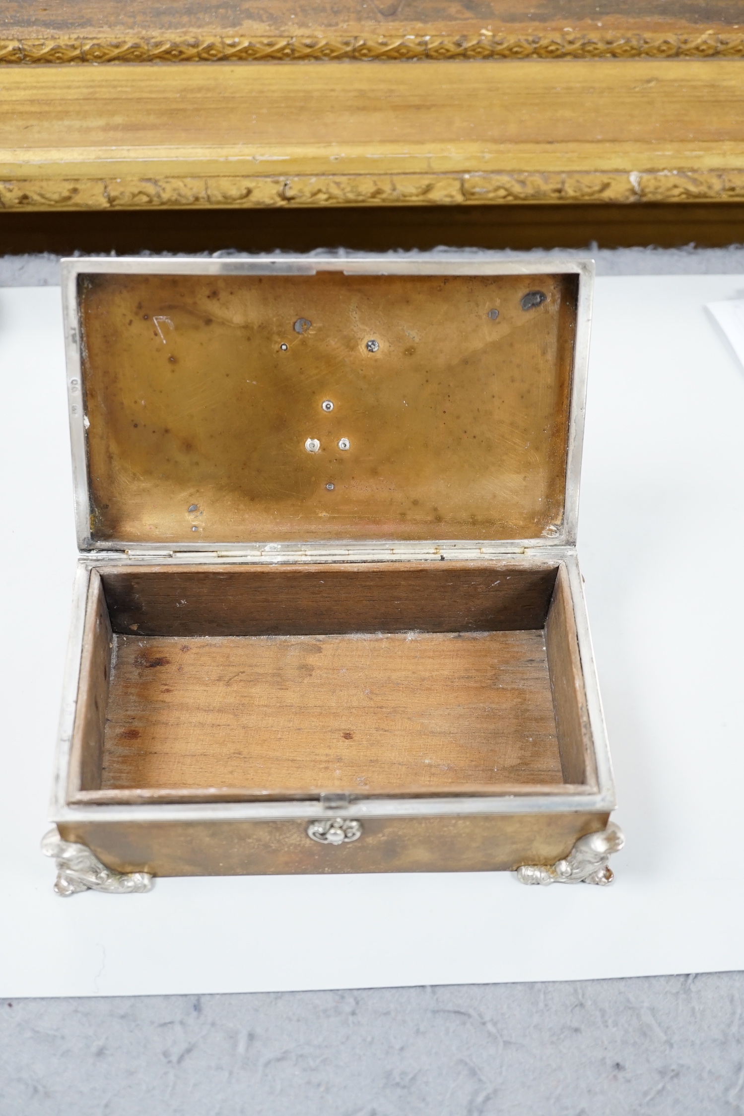 An unusual late Victorian silver mounted brass rectangular cigarette box, with applied monogram, Alfred Fuller, London, 1885, 16.4cm.